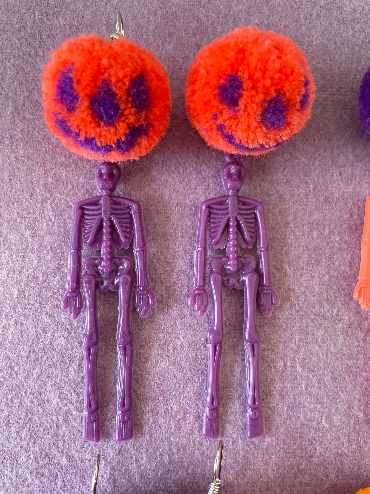 Pumpkin skeleton pompom earrings orange and purple