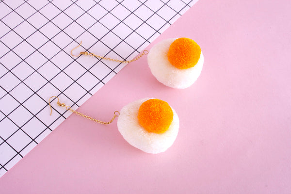 egg pom pom earrings